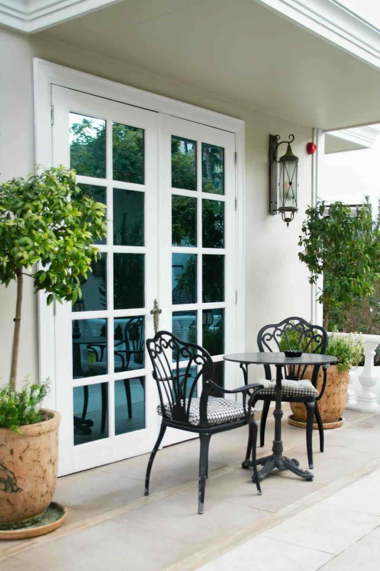 French doors to outdoor patio, with wrought iron furniture - Pinnacle Home Improvements