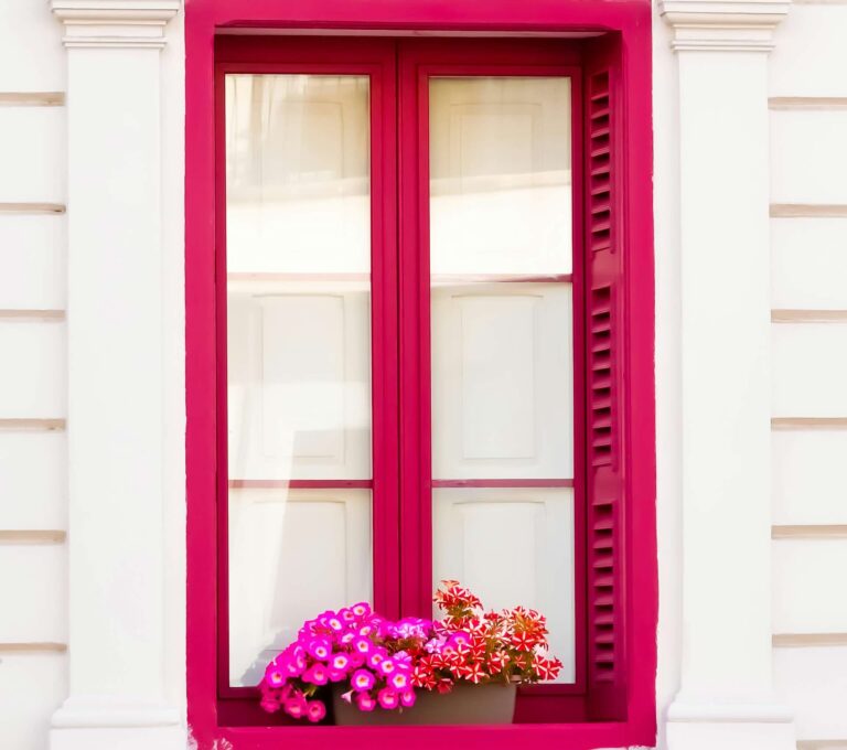 Windows with red frames and pink flowers - Pinnacle Home Improvements