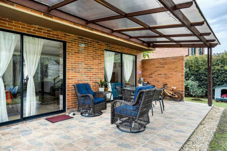 Sliding patio doors, with wicker chairs and plants - Pinnacle Home Improvements