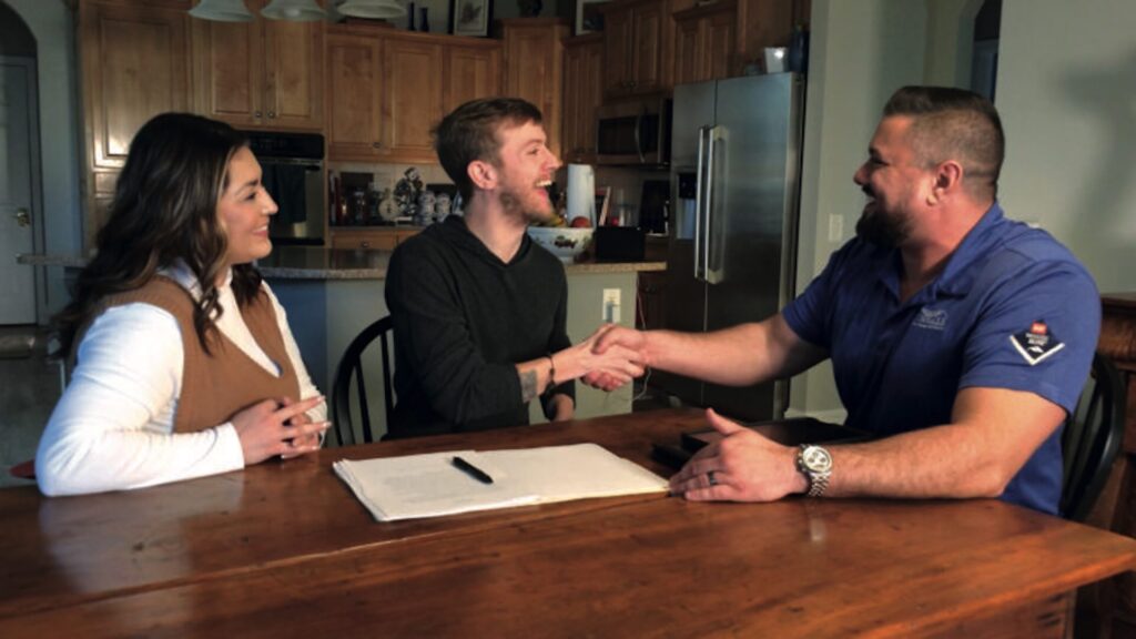 Woman and man clients meeting with male Pinnacle Home Improvements representative